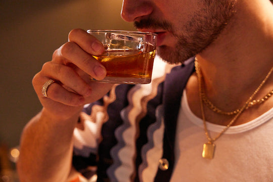Bearded man sipping Las Olas from glass