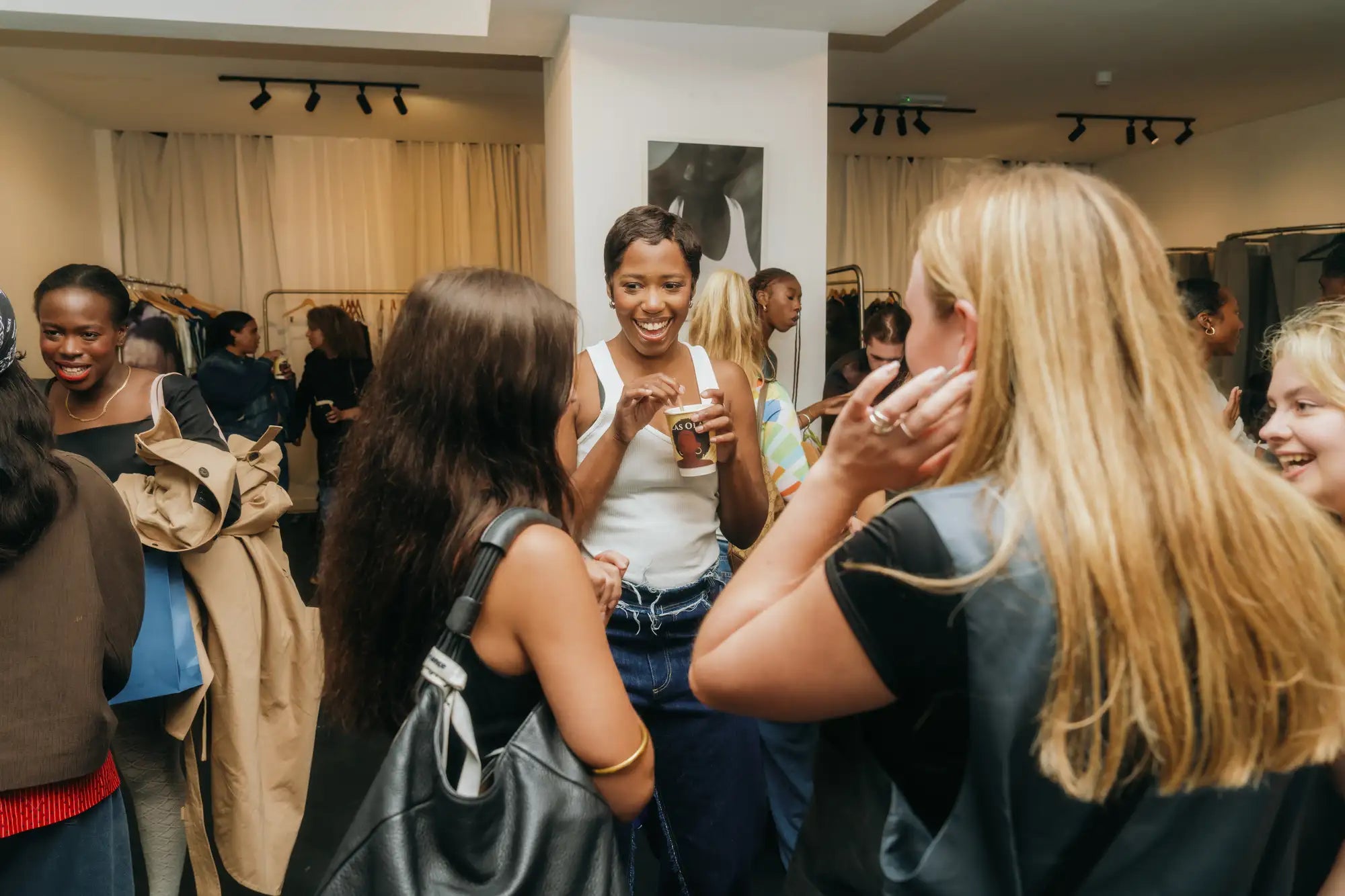 Group of people in a social setting, possibly a store or event space.