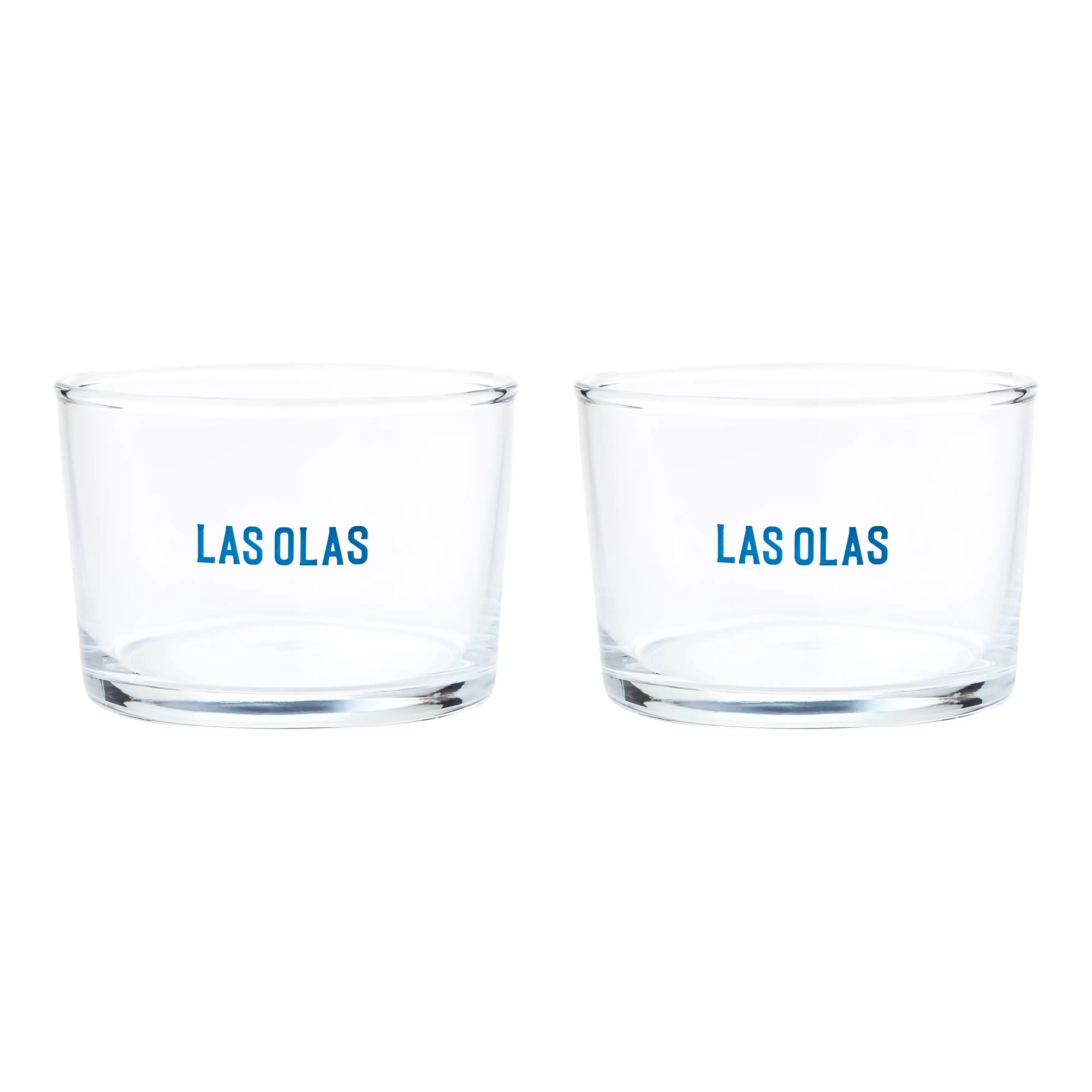Two clear glasses with 'LAS OLAS' text on a white background