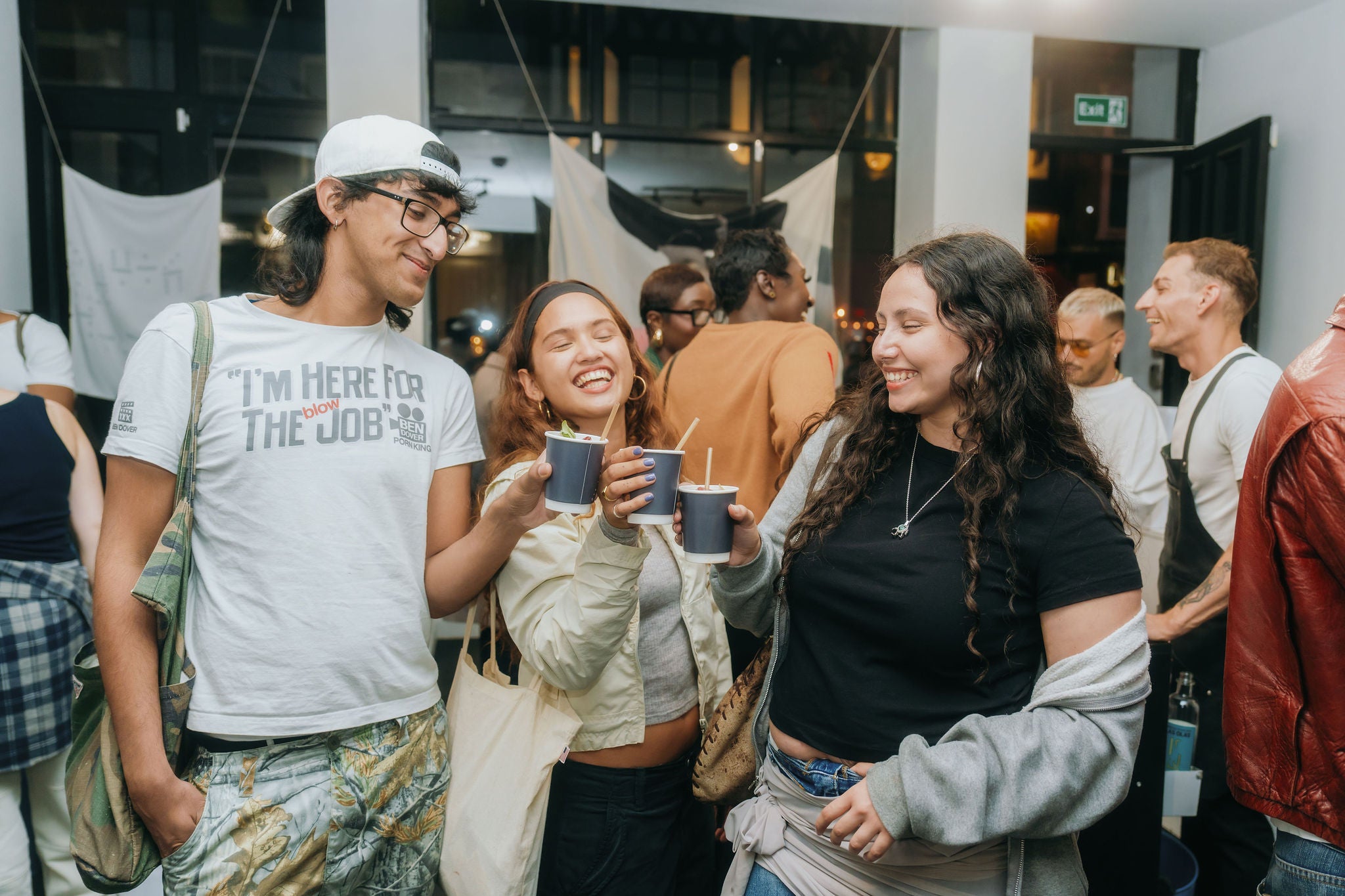 Group of people socializing and drinking at a casual event.